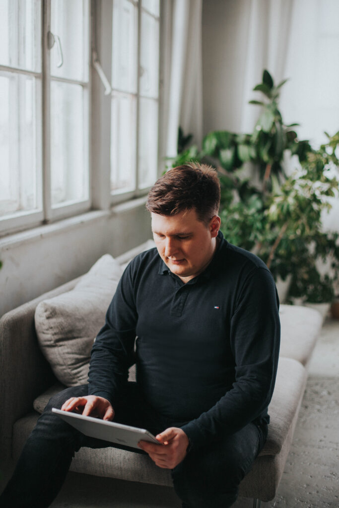 Fizjoterapeuta Łukasz Kusowski trzymający tablet